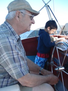 Hector Jourdain and his youngest grandson on bridge of the Bluefin
